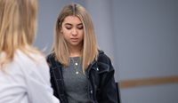 Young woman having serious discussion with GP.