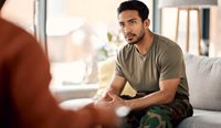 Young male veteran talking with GP